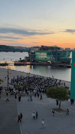 Evening crowds gather at Seoul waterfront during colorful sunset