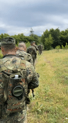 Military personnel conduct operations with equipment deployment observed