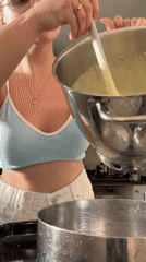 Thick batter poured between mixing bowls in Tel Aviv kitchen