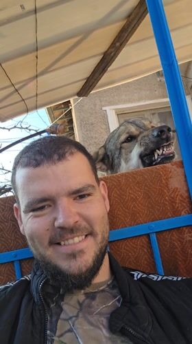 Dog photobombs man's selfie on bench in Bulgaria