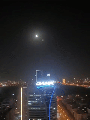 Dubai nighttime cityscape captured across multiple locations under full moon