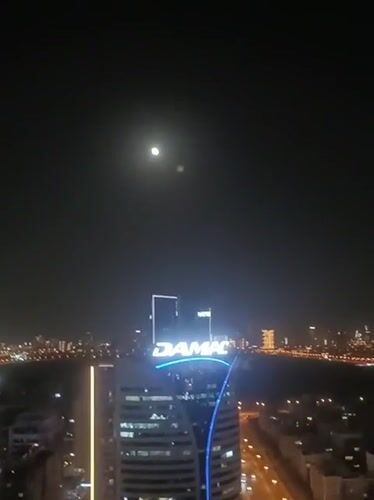 Dubai nighttime cityscape captured across multiple locations under full moon