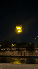 Hot air balloon glows over the Seine on a Paris night
