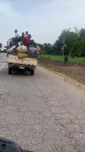 Loaded truck carries passengers on damaged road in Nigeria
