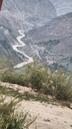Cloudy morning around Keylong — river, peaks, prayer flags, and town
