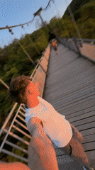 Young man takes selfie on wooden bridge in Yongding District