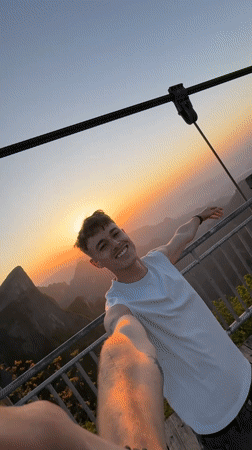 Young man takes selfie on wooden bridge in Yongding District
