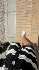 Woman documents walk with selfies and street footage