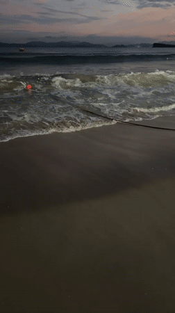 Beachgoers gather at dusk in Longgang District, China