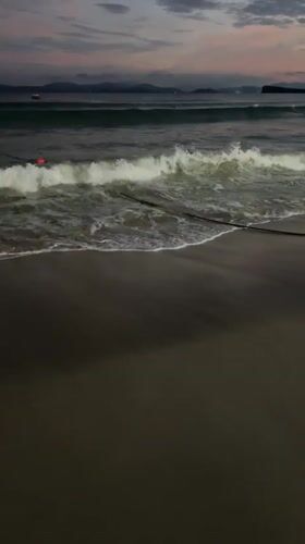 Beachgoers gather at dusk in Longgang District, China