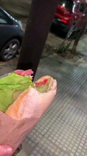 Man eats sandwich in Buenos Aires evening