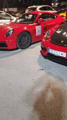 Luxury sports cars gather near Aperi building evening May 2