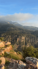 Tourists document scenic clifftop views in Fethiye, Turkey