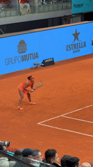 Professional tennis match observed on indoor clay court in Madrid