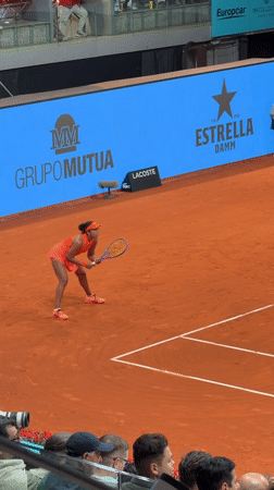 Professional tennis match observed on indoor clay court in Madrid