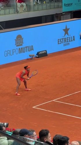 Professional tennis match observed on indoor clay court in Madrid