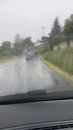 Tractor spotted on wet road in Chambœuf during morning commute