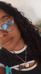 Person with curly hair, gold necklace documented twice Sunday morning