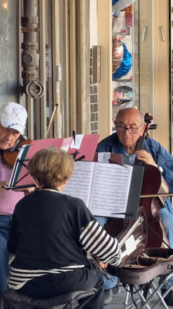 Street musicians perform in Tel Aviv amid scooter traffic
