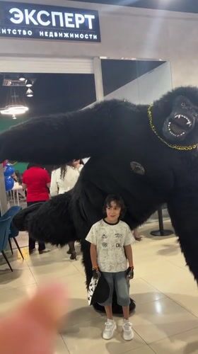 Child poses with costumed performer in Russian indoor venue