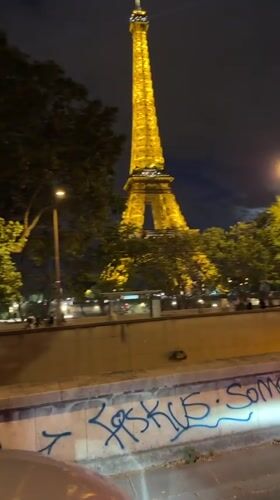 Eiffel Tower glowing gold on a July night in Paris