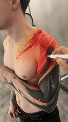 Tattoo artist sketches design on client's shoulder in Moscow