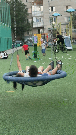 Evening in an Astana neighborhood — playgrounds, bikes, and a dusk sky