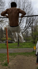 Man exercises shirtless at Sofia park using outdoor equipment