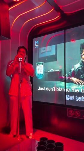 KTV session in a neon-lit karaoke room, Haizhu District