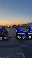 Children's rides operate at dusk in Novorossiysk park
