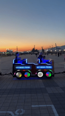 Children's rides operate at dusk in Novorossiysk park