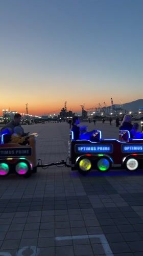 Children's rides operate at dusk in Novorossiysk park