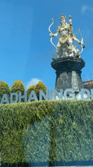 Roadside sign photographed from vehicle in Kuta Selatan, Indonesia