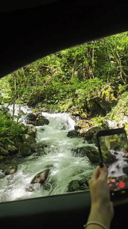 Tourist documents Lake Ritsa scenery and forest stream in Abkhazia