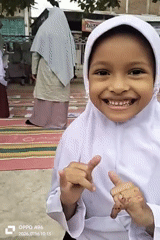 Smiles and peace signs at a school or community gathering