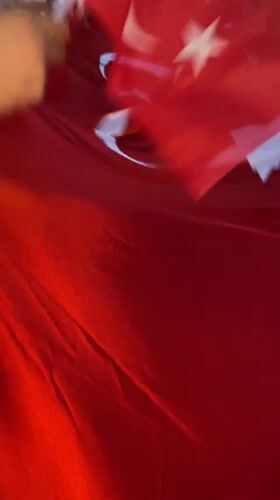 Crowd holds Turkish flag during evening gathering in Alanya