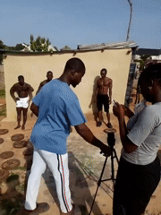 Men conduct outdoor fitness training with metal weights