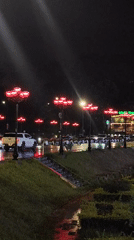 Nighttime Da Lat cityscape captured around illuminated Xuan Huong Lake