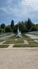 Man stands in London park fountain with yellow object