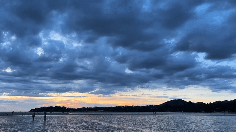Sunset watchers gather on Ko Pha-ngan sandbars during low tide