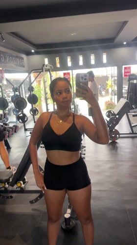 Woman takes mirror selfies at Indonesian gym