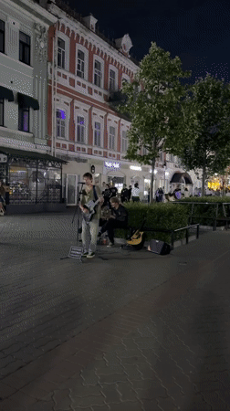 Live guitar on Kazan streets, dragon sculptures nearby