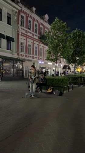 Live guitar on Kazan streets, dragon sculptures nearby
