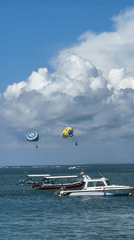 Morning parasailing and kite flying spotted off southern Bali coast