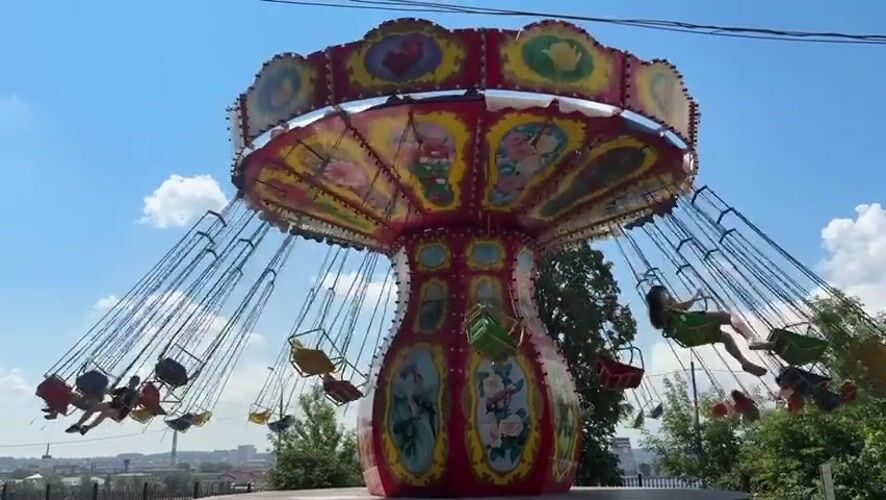 Morning at Izhevsk amusement park with rides and games