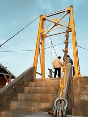 Pedestrians visit yellow suspension bridge in Lhokseumawe, Indonesia