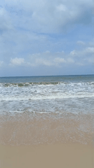 Quiet morning on the Mũi Né shoreline, cloudy skies overhead
