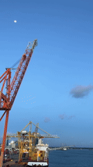 Port operations documented during twilight hours at industrial facility