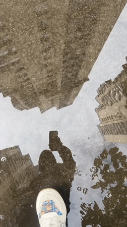 Moscow resident documents rainy morning reflections of city skyscrapers