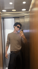 Man takes selfie in London elevator